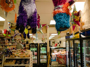 a store with a large display of colorful balloons