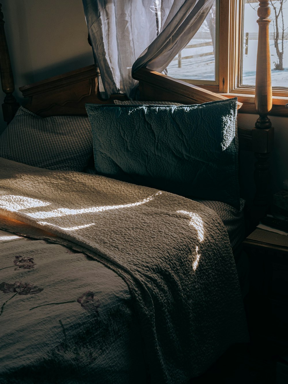 a bed with a green pillow