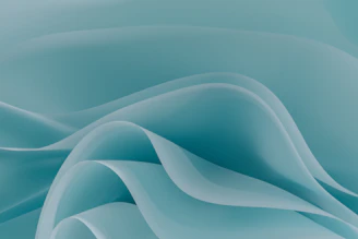 Smooth flowing teal waves with soft shadows and overlapping curves