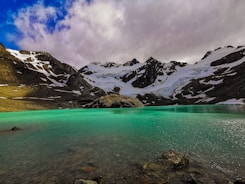 a body of water with mountains in the back