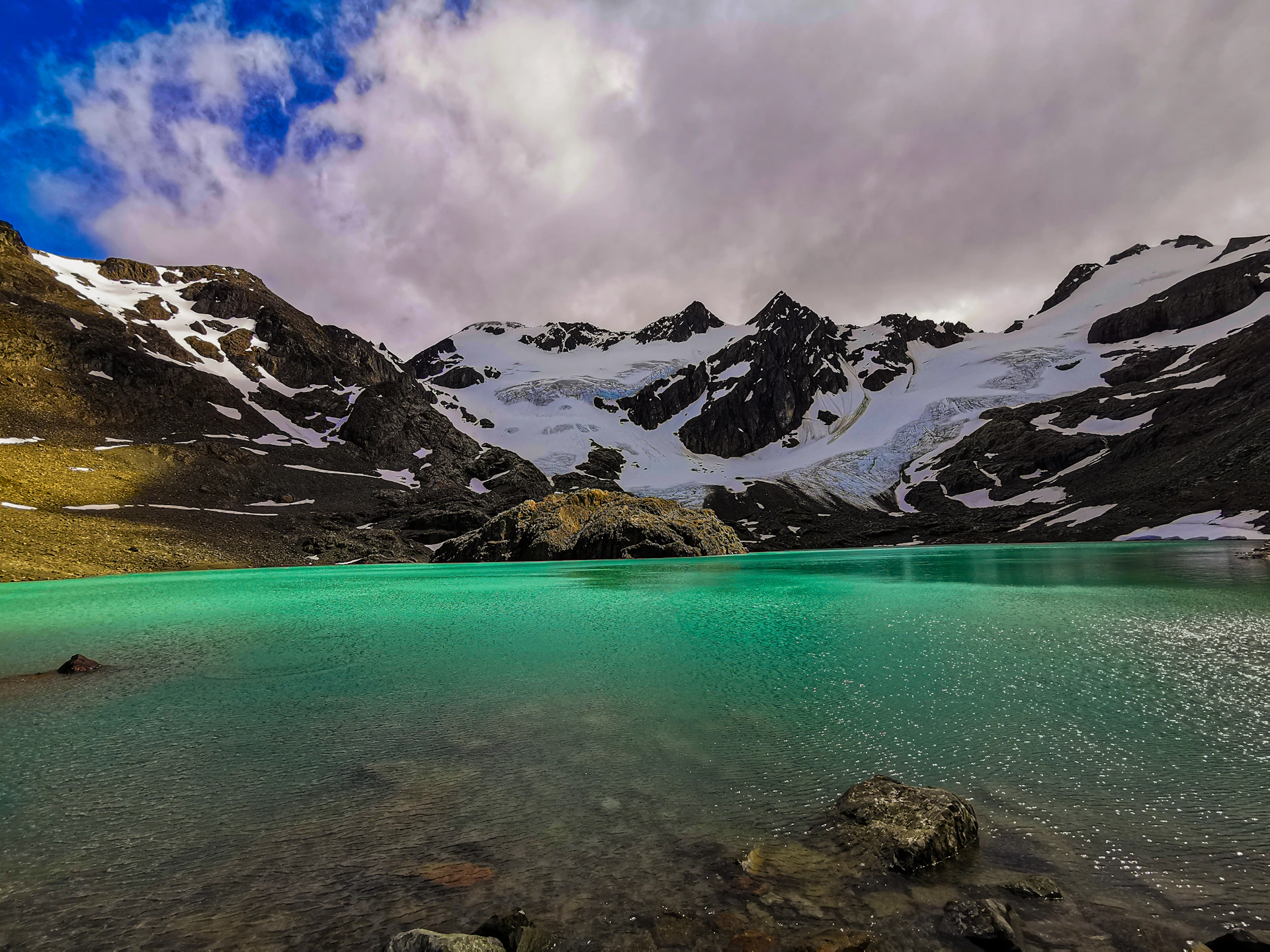 a body of water with mountains in the back