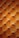 A detailed close-up of a tufted leather surface featuring a grid of cushioned, diamond-shaped patterns. The leather appears soft and plush, with stitching forming the intersections, creating a luxurious and ornate texture.