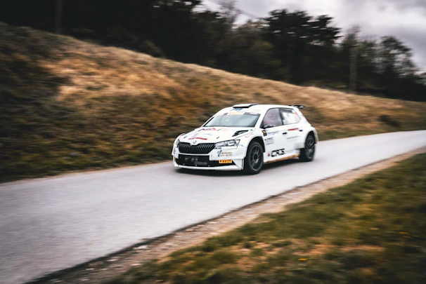 Close-up of a rally driver intensely focused during a high-speed corner.