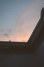 A peaceful sunrise view through a window, suggesting a fresh start to the day.