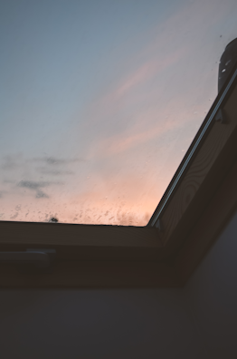 A gentle sunrise viewed through a window, symbolizing new beginnings.
