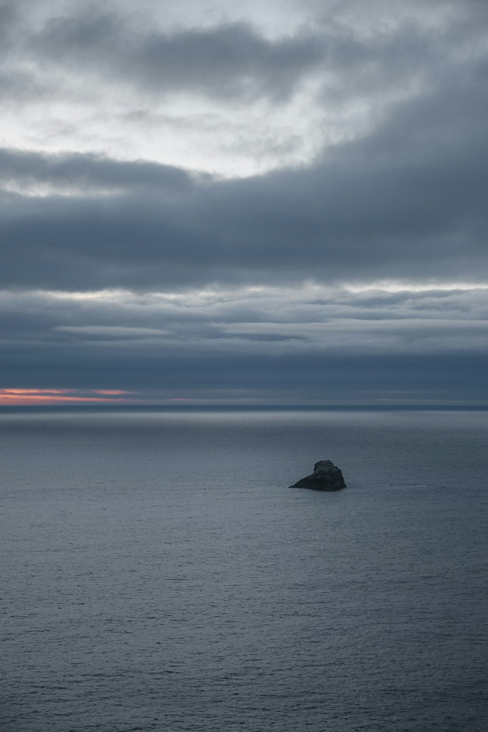 a rock in the middle of a body of water