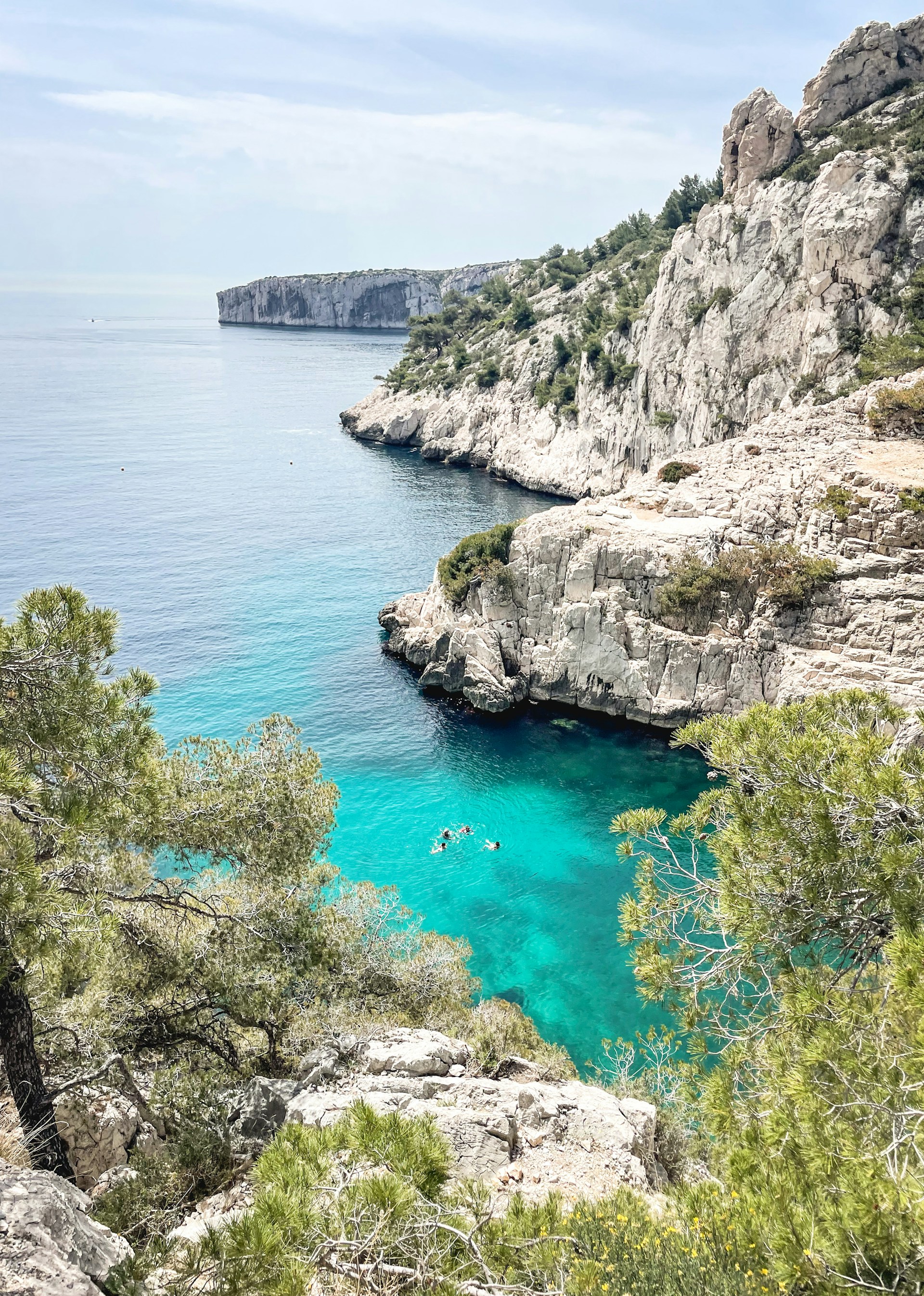 a rocky cliff with a body of water below
