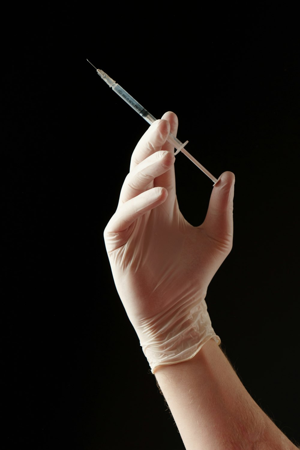 a hand holding a needle