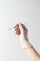 a hand holding a needle