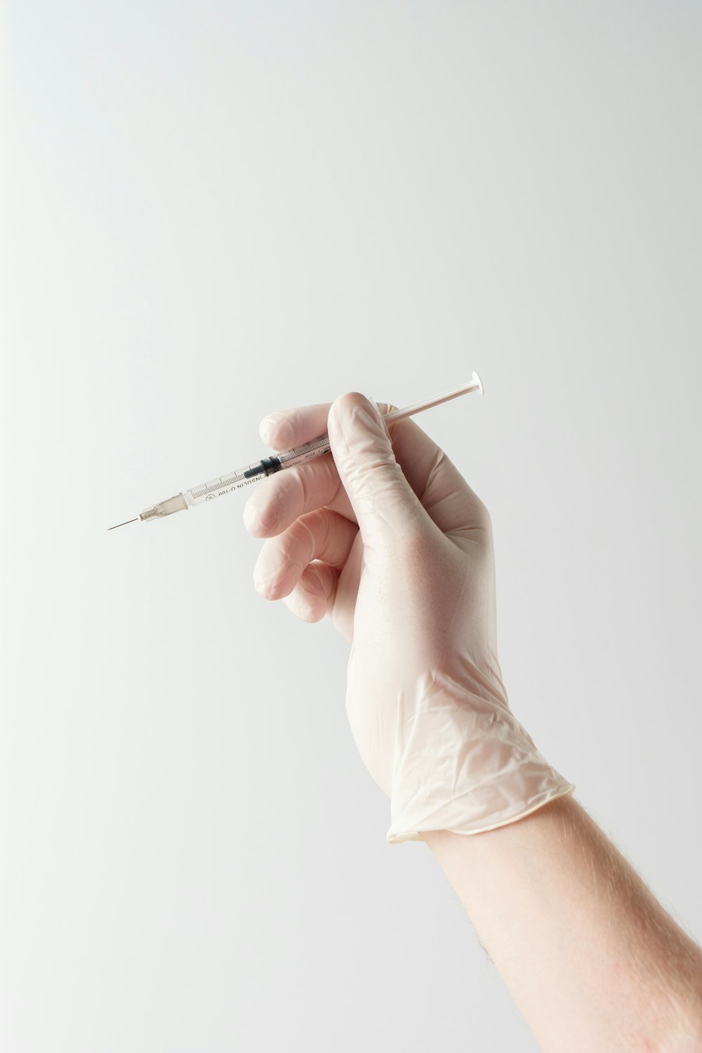 a hand holding a needle