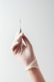 a hand holding a needle