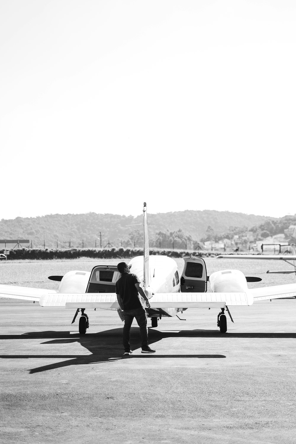 a man standing next to a small plane