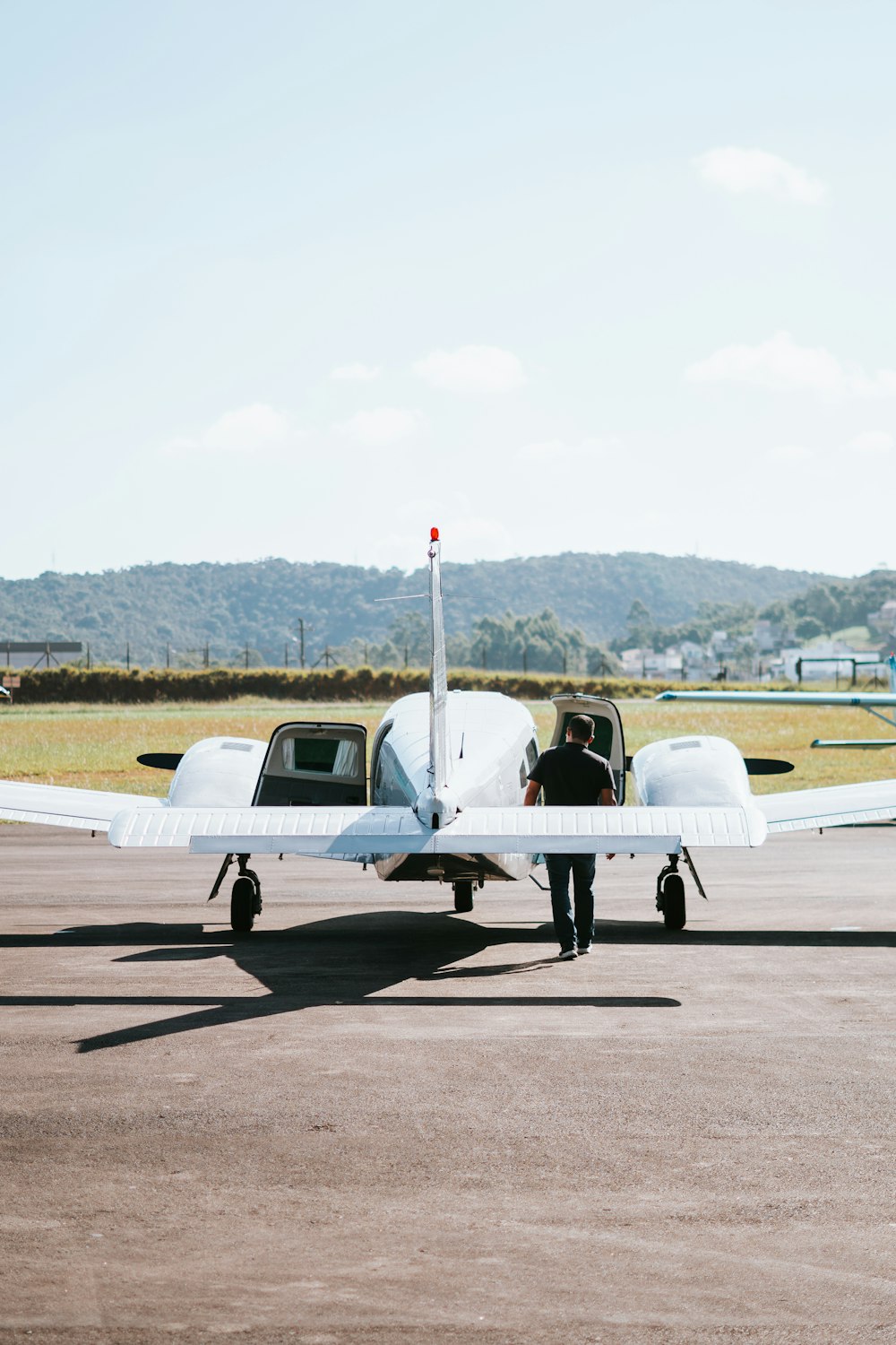 a person standing next to a small airplane