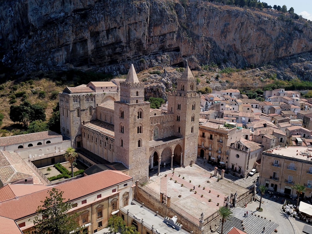 a large building with a hill in the background