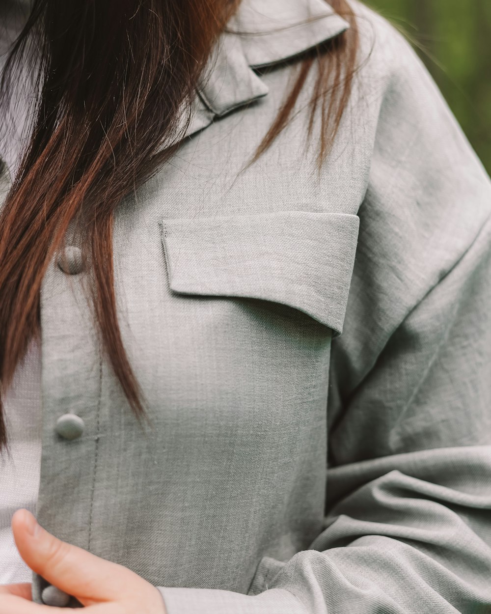 a woman wearing a grey jacket