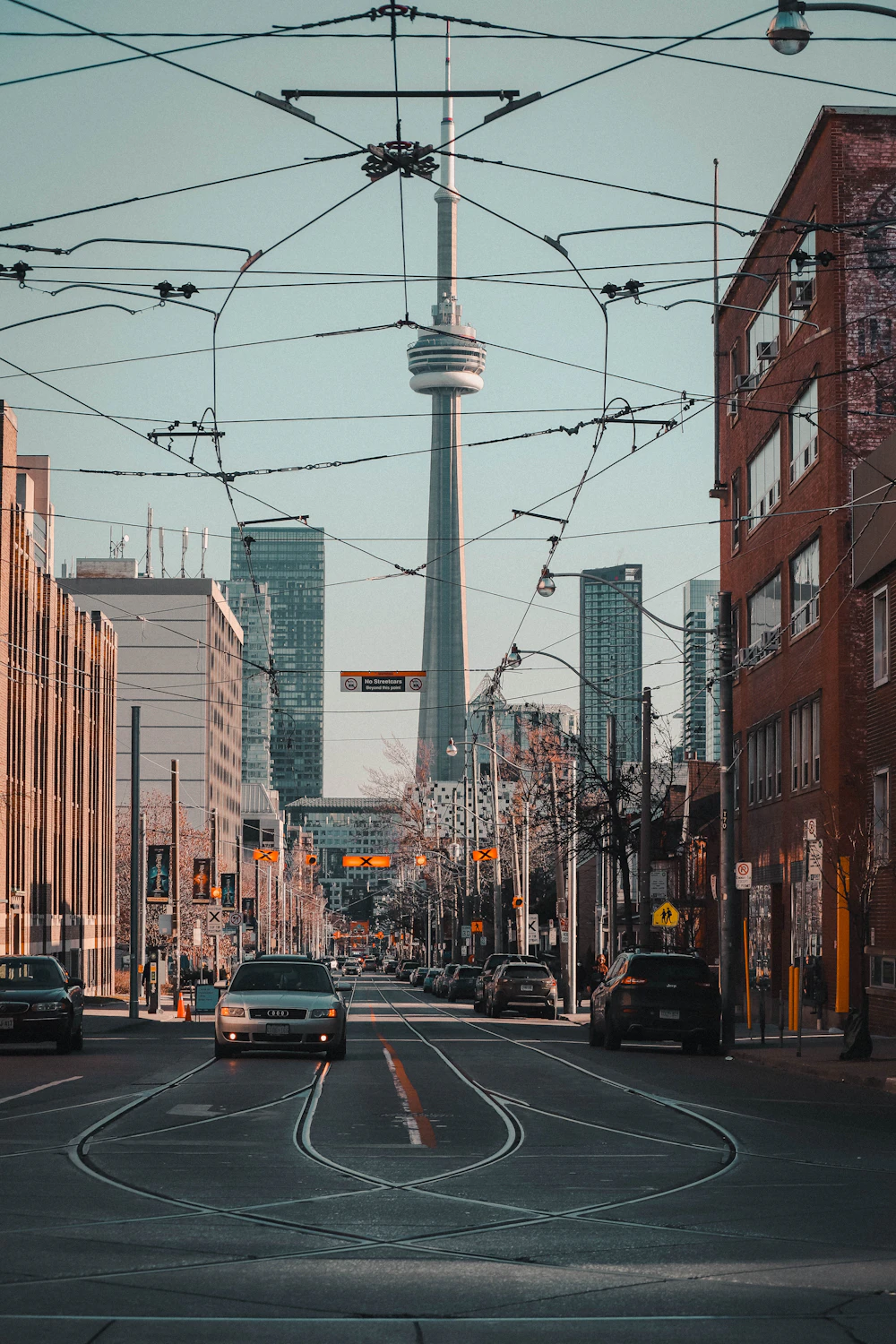 View of the CN Tower down King Street with streetcar tracks