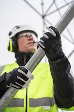a person wearing a helmet and goggles holding a pole