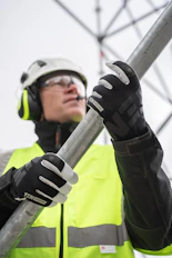 a person wearing a helmet and goggles holding a pole