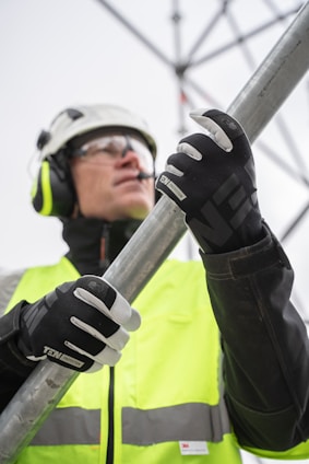 a person wearing a helmet and goggles holding a pole