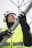 a person wearing a helmet and goggles holding a pole