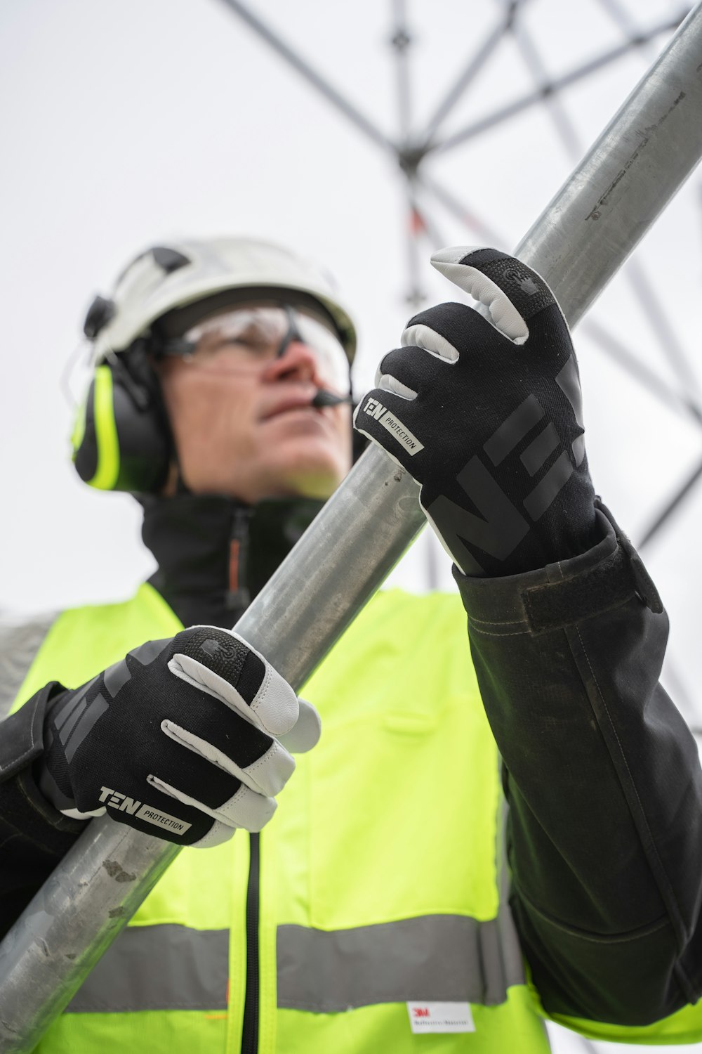 a person wearing a helmet and goggles holding a pole