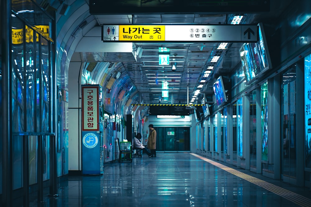 a man and a woman walking in a hallway