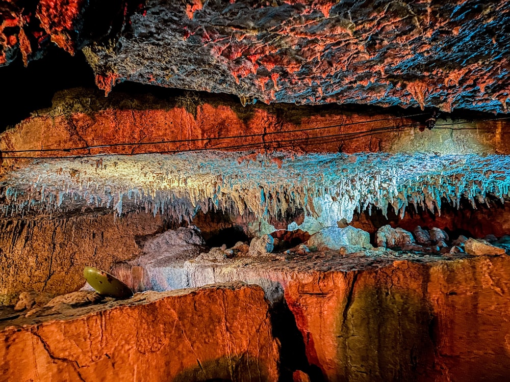 a rock wall with a blue and red rock formation