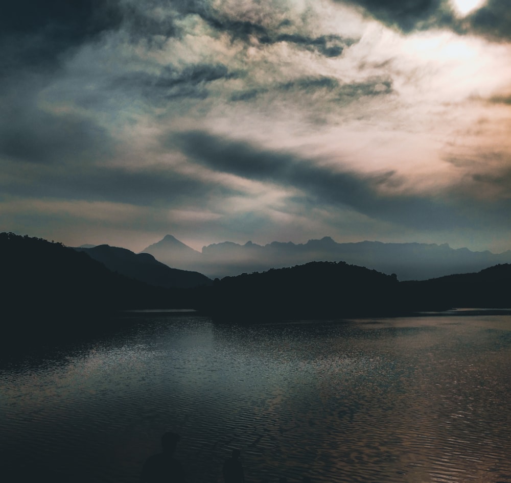 a body of water with mountains in the background