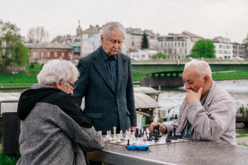 a group of people playing chess