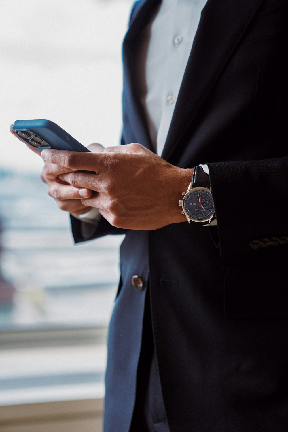 a man in a suit holding a cell phone