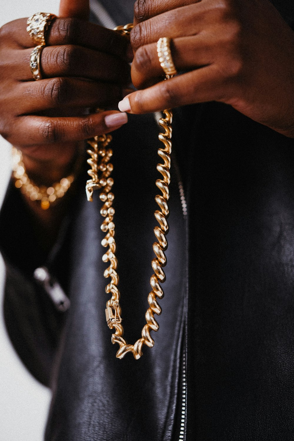 a person tying a necklace