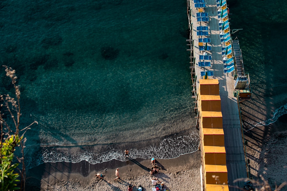 a beach with people and a building