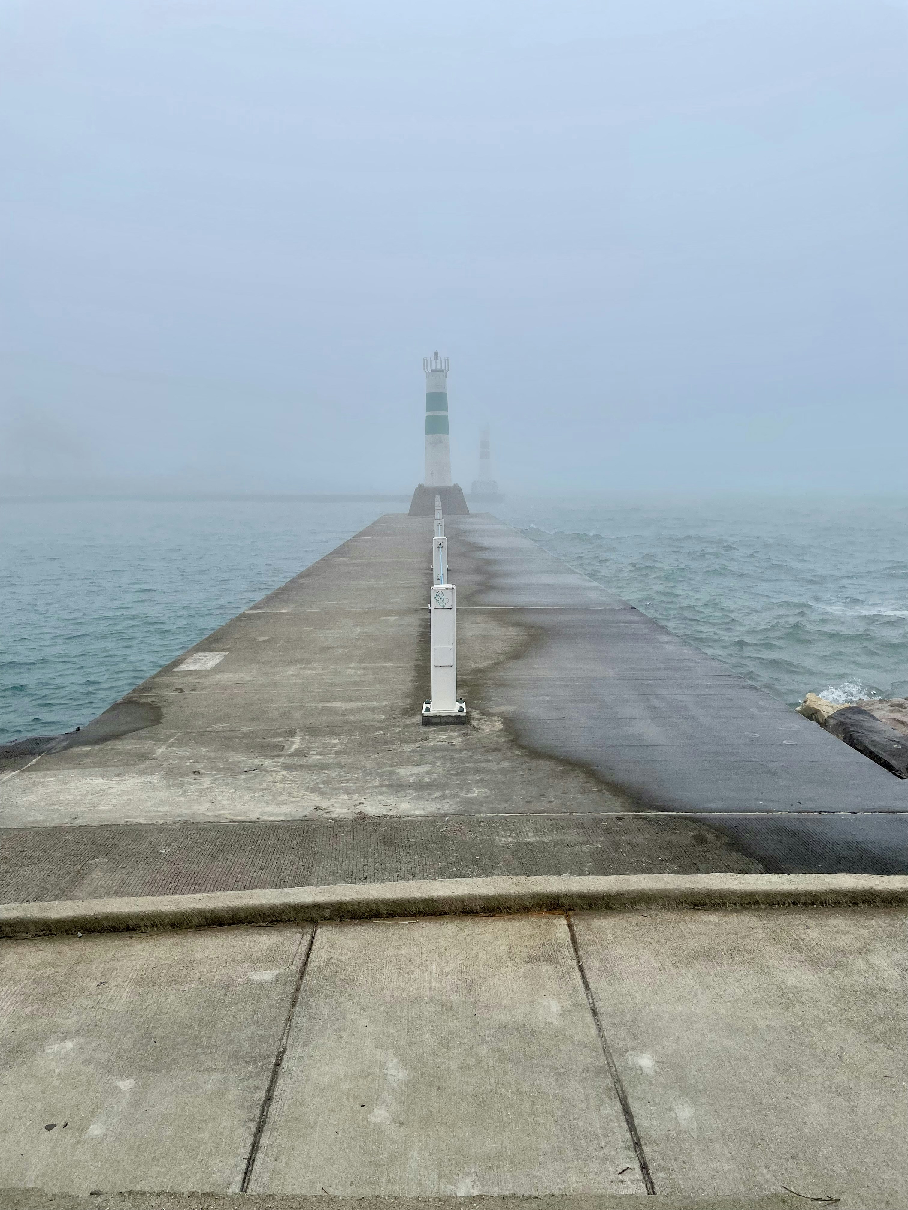 a stone walkway leading to a lighthouse