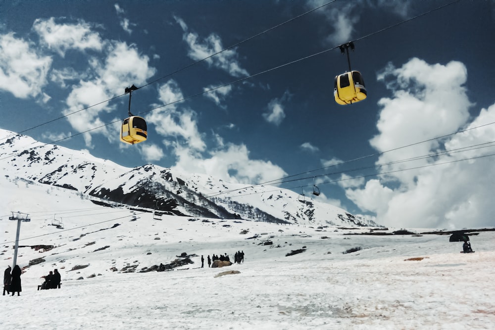 a ski lift going up a snowy mountain