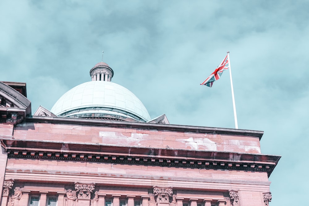 a flag flying on top of a building