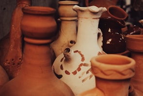 A serene shot of handcrafted pottery resting on a dark charcoal surface, highlighting earthy textures.