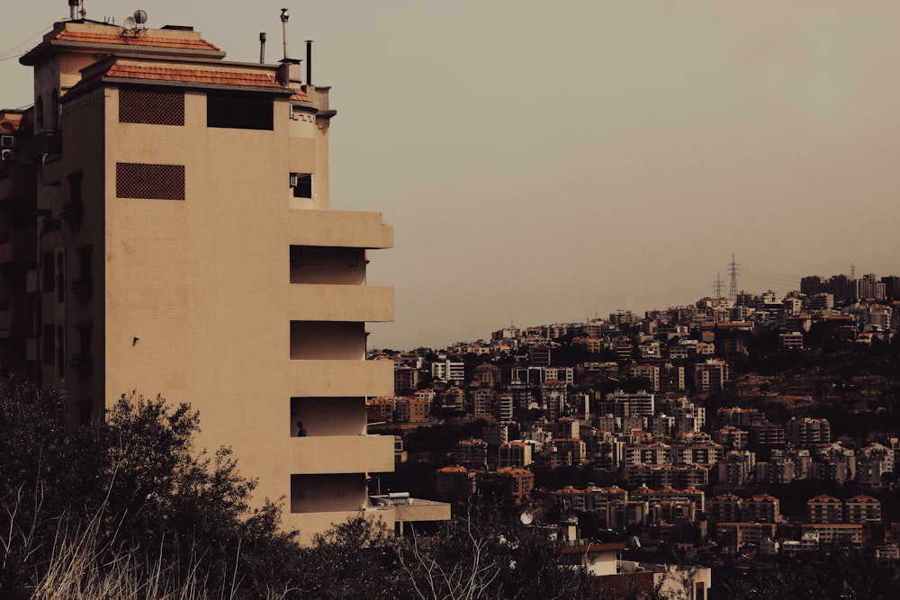 a tall building with a city in the background