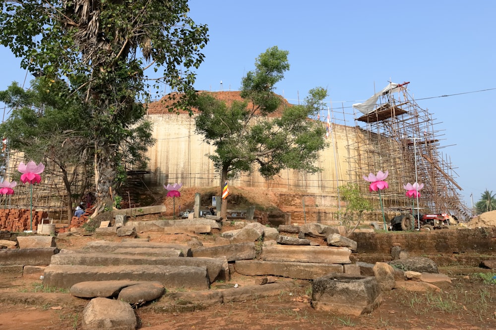 a stone structure with a ferris wheel in the background