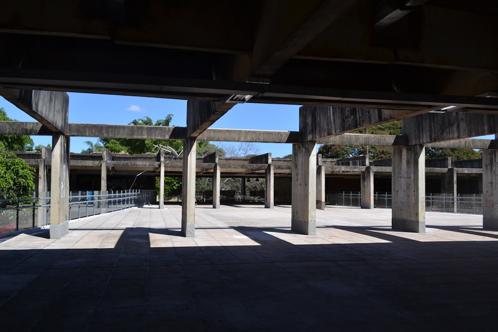 a concrete walkway with a bridge over it