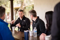 a group of people sitting at a table