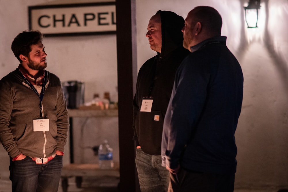 a group of men standing in a room