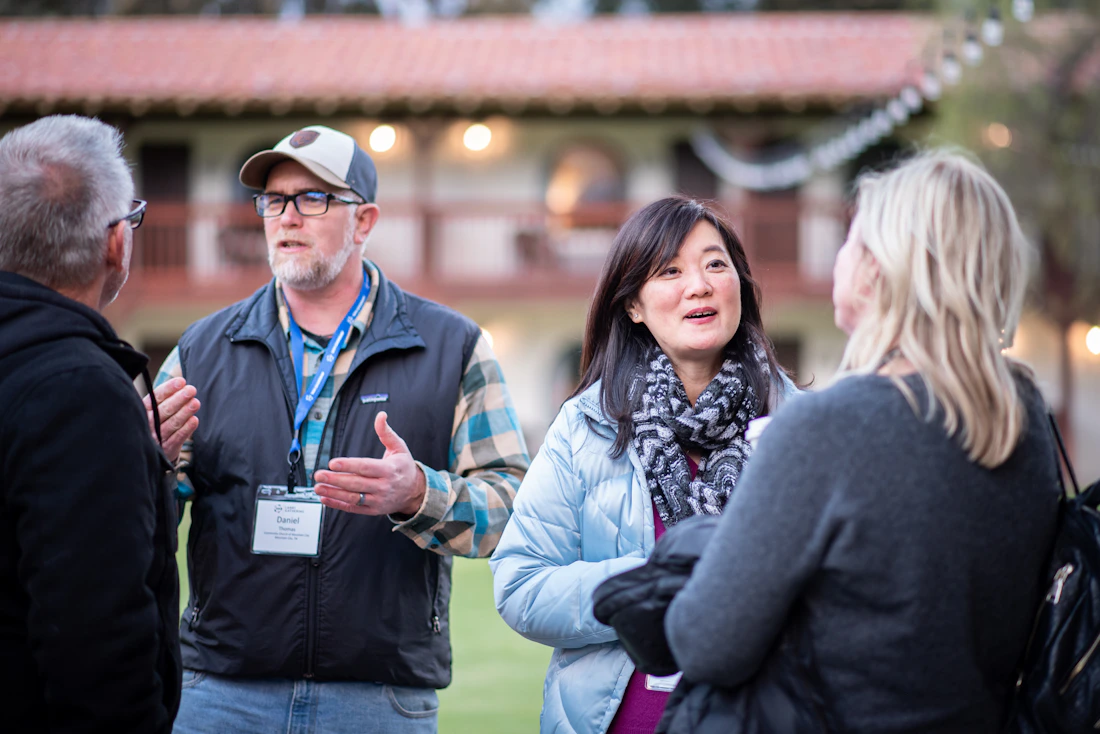 Adults sharing conversation and fellowship at a church small-group gathering