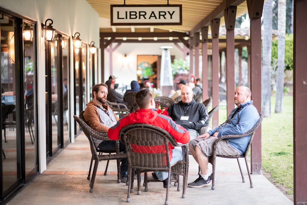 a group of people sitting outside a restaurant