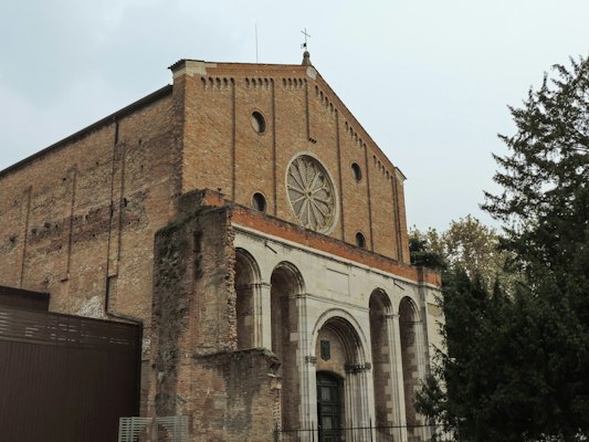 A large brick building with a clock on it — Padua, Italy