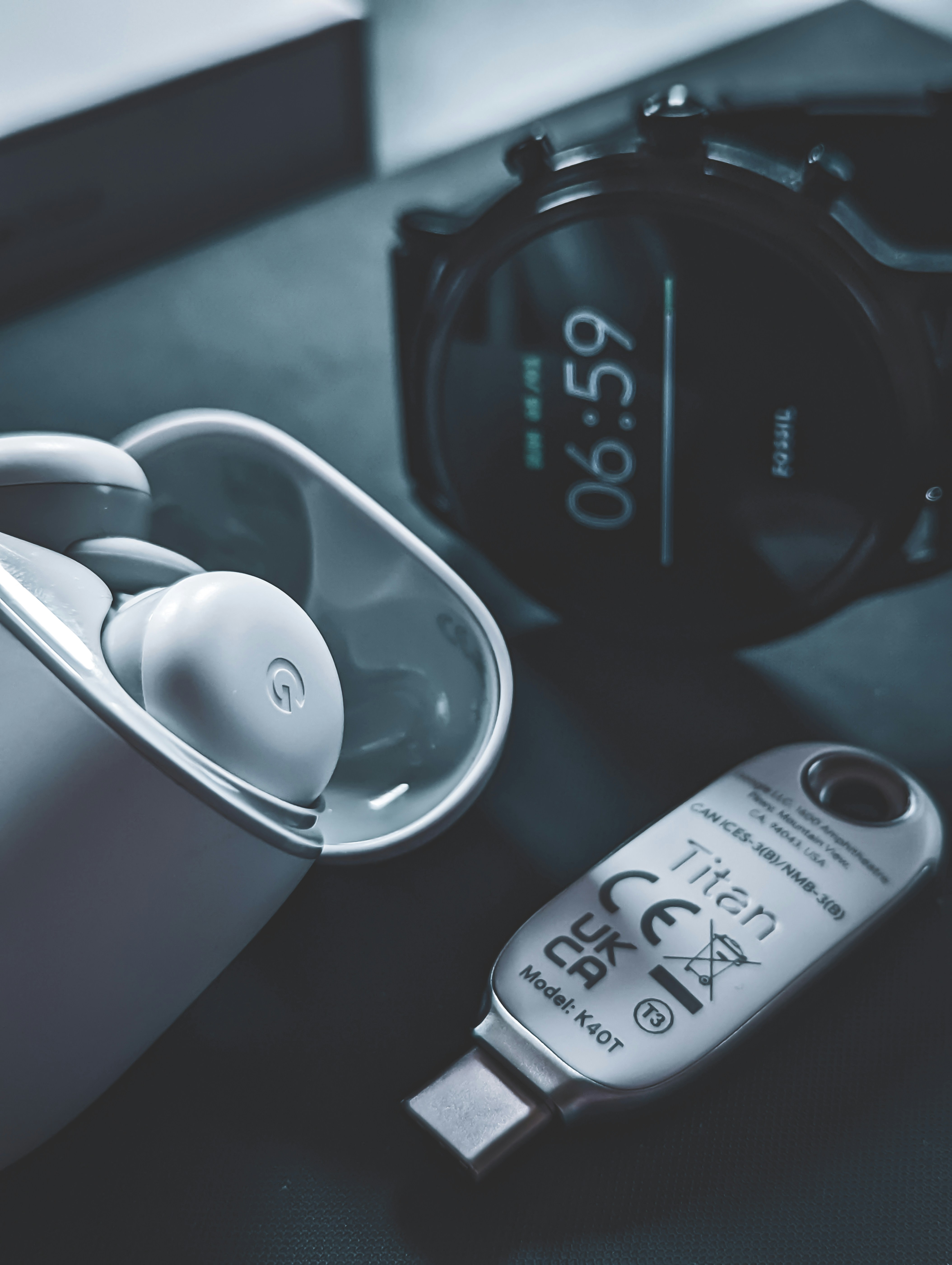 Branded USB drives and power banks arranged on dark surface, tech product photography