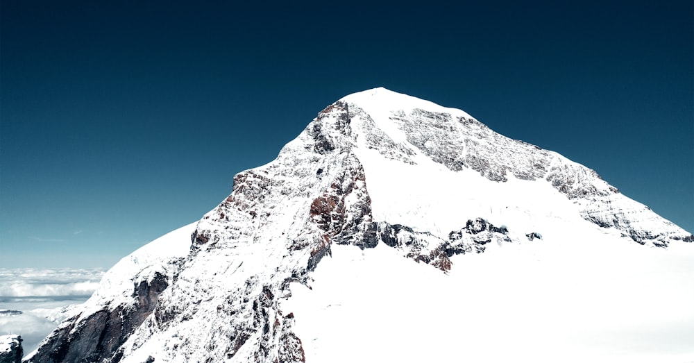 a snowy mountain with a blue sky