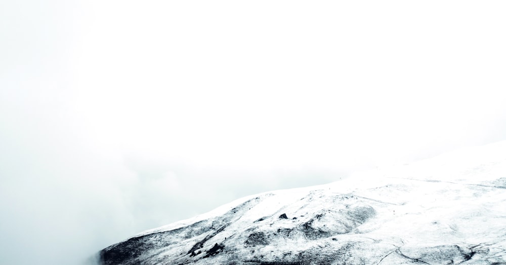 a snowy mountain with a trail