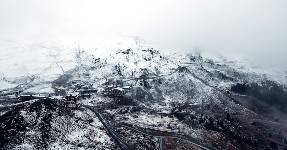 a train track going through a snowy mountainous region