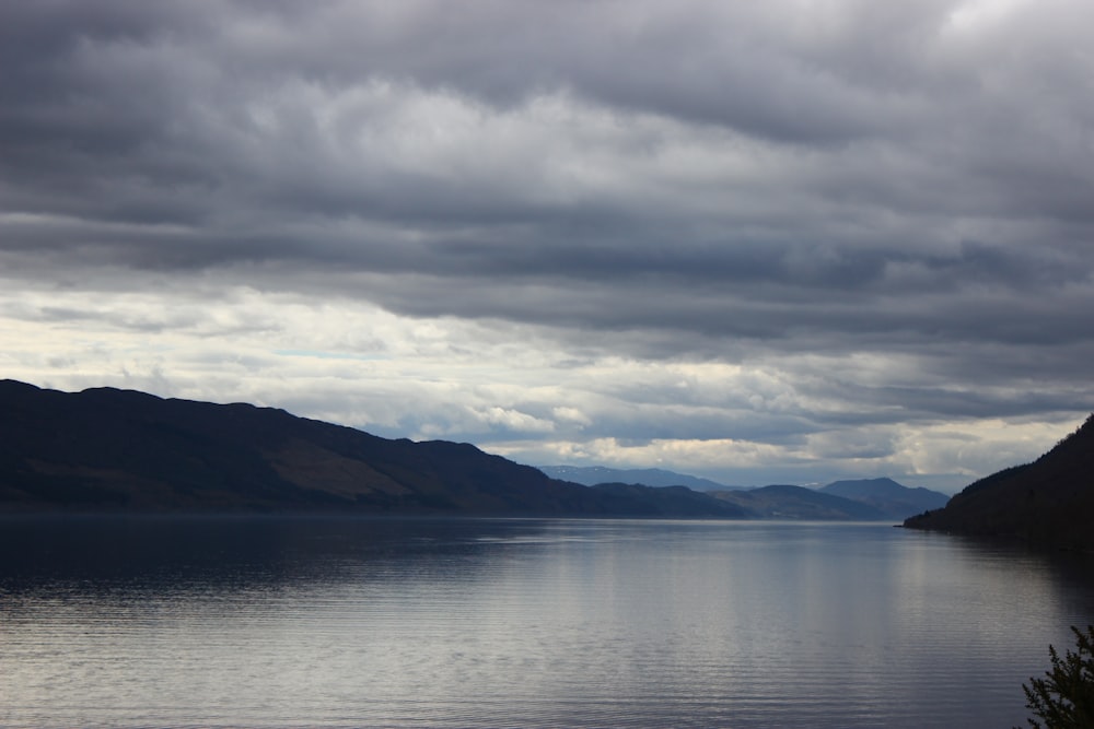 a body of water with mountains in the background