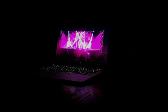 Vibrant concert scene with branded merchandise and a dynamic website on a laptop screen.